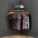 Use a corner clothes rail with grid mesh panels for retail clothing displays