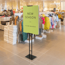 Adjustable Double Sided Poster Display Stand in a retail store