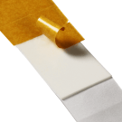 Double sided adhesive foam pads in rolls of 2000